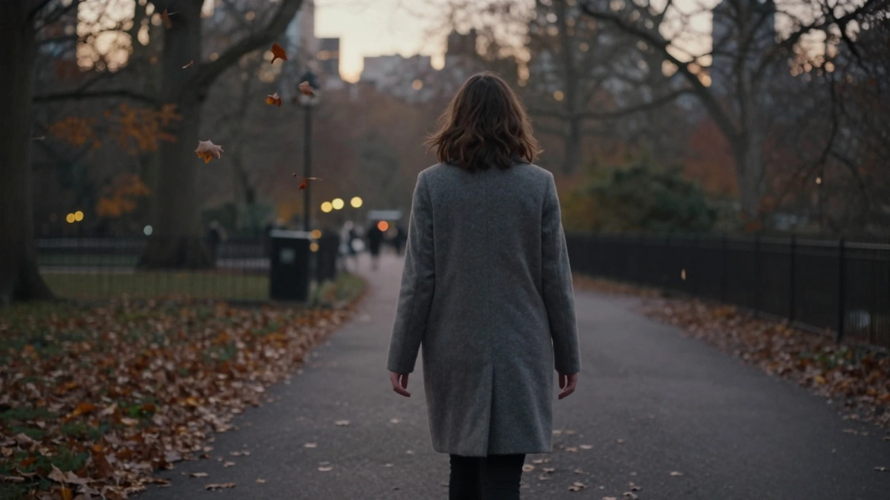 A woman walking calmly through Hyde Park at dusk, autumn leaves falling around her.