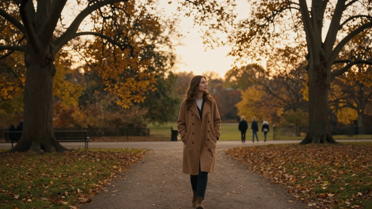 A woman walking peacefully through Hyde Park at sunset, hands in pockets.