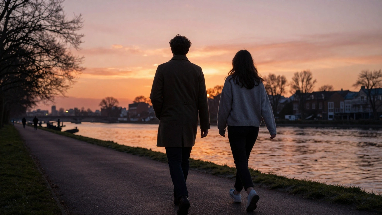 Two people walking peacefully along the Thames at sunset, faces unseen.