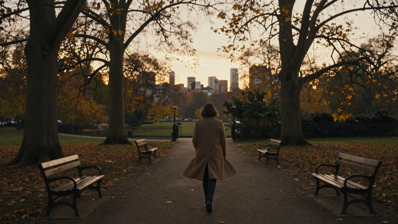 Person walking alone through Hyde Park at sunset, autumn trees, peaceful solitude.