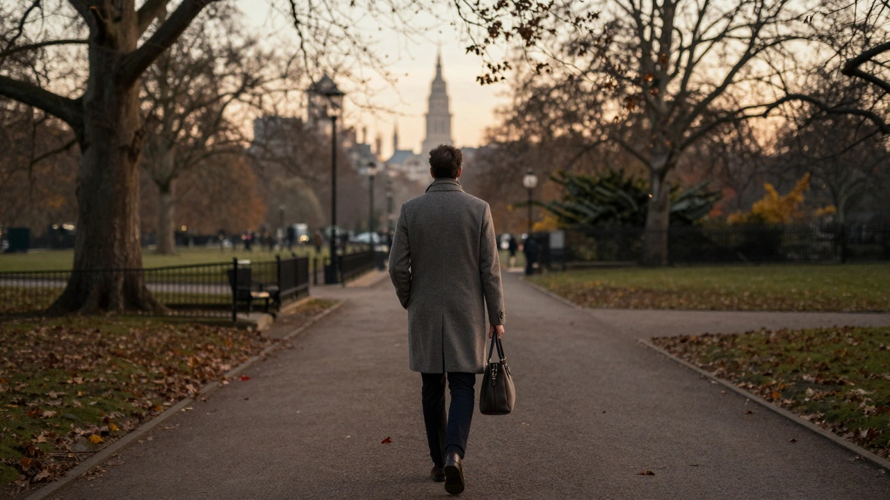 A well-dressed person walking alone through Hyde Park at sunset, autumn leaves falling gently.