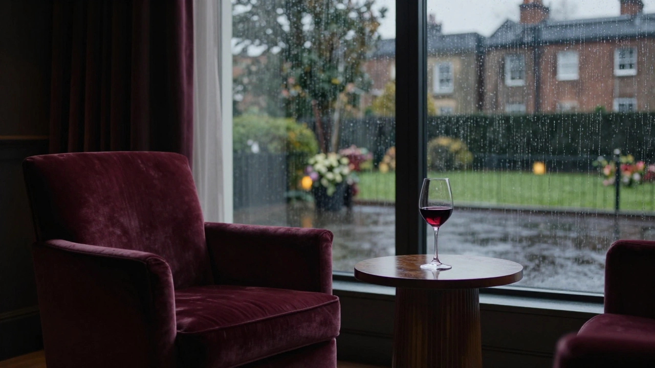 Dimly lit luxury room with wine and velvet chair.